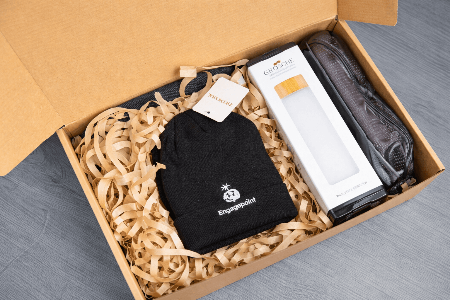 Close-up of swag pack containing beanie, water bottle and bag decorated with client logo