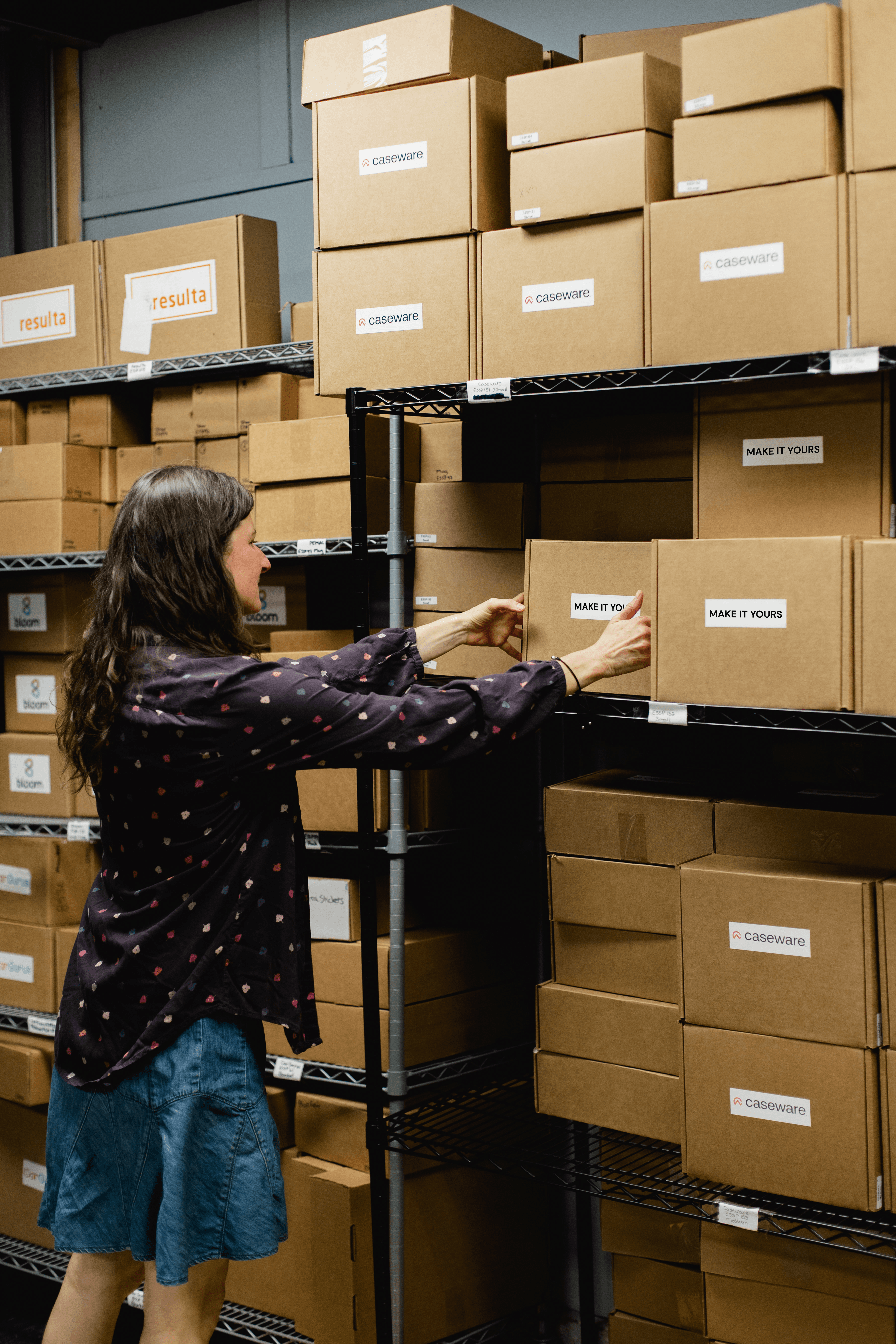 Team member picking branded merchandise from warehouse storage shelves