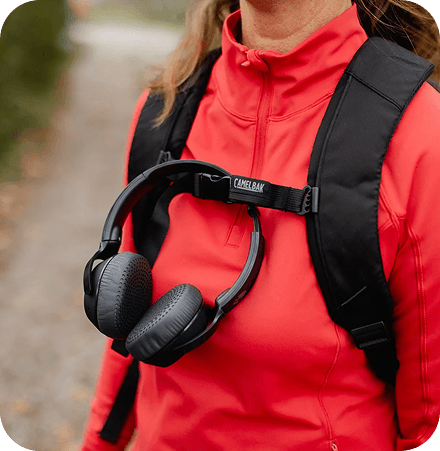 A person wearing a red hoodie and headphones, suggesting readiness and modern branding.